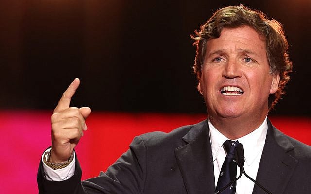 US political commentator Tucker Carlson speaks during the public memorial service for right-wing activist Charlie Kirk at State Farm Stadium in Glendale, Arizona, on September 21, 2025. (Patrick T. Fallon / AFP)