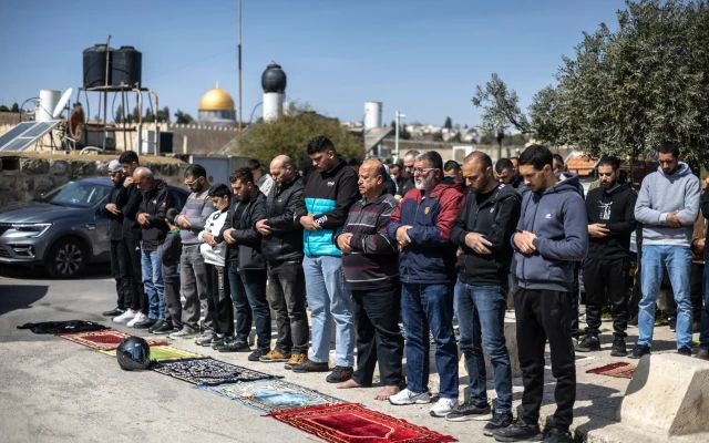 Muslim worshippers perform Friday prayers on the streets of Ras al-Amud in East Jerusalem, overlooking the Al-Aqsa Mosque and the Dome of the Rock, on March 6, 2026. (OLYMPIA DE MAISMONT / AFP)