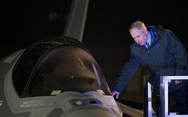 FILE - In this Dec. 12, 2016, file photo, Israeli Prime Minister Benjamin Netanyahu reaches to one of the first two next-generation F-35 fighter jets after it landed during an unveiling ceremony upon arrival in Nevatim Air Force Base near Beersheba, Southern Israel. A U.S.-brokered deal that saw Israel and the United Arab Emirates begin to open diplomatic ties may end up with Abu Dhabi purchasing advanced American weaponry like the F-35, potentially upending both a longstanding Israeli military edge regionally and the balance of power with Iran. (AP Photo/Ariel Schalit, File)