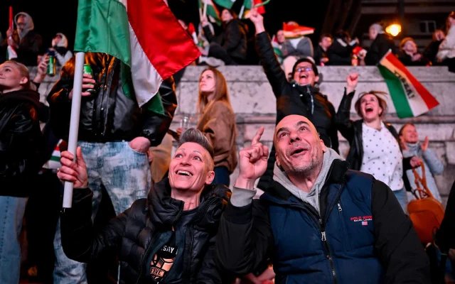 People react in the streets after the announcement of partial results of the Hungarian parliamentary in Budapest, Hungary, April 12, 2026. (AP Photo/Denes Erdos)