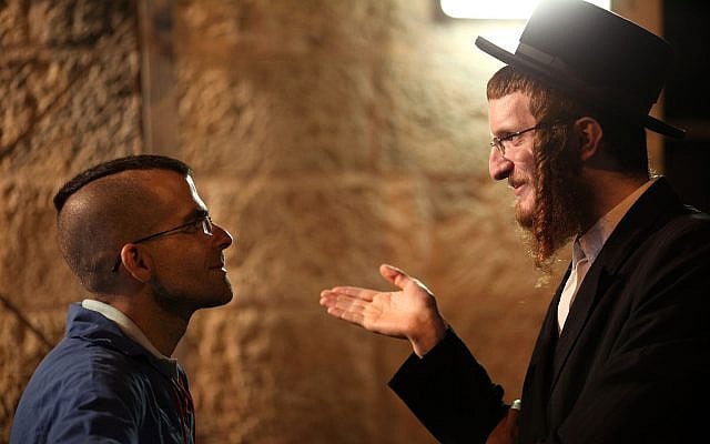 Illustrative: An ultra-Orthodox Jewish man speaks with with a non-religious person during a demonstration in central Jerusalem. Monday, Aug 01, 2011. (Kobi Gideon / Flash90) Illustrative: An ultra-Orthodox Jewish man speaks with with a non-religious person during a demonstration in central Jerusalem. Monday, Aug 01, 2011. (Kobi Gideon / Flash90)