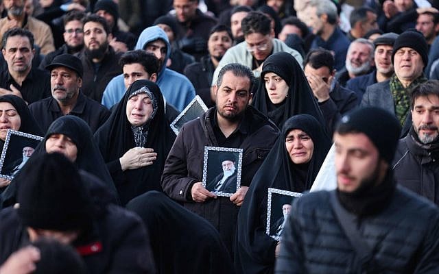 People mourn the death of Iran's supreme leader Ayatollah Ali Khamenei, who was killed in joint US and Israeli strikes, at a square in Tehran on March 1, 2026. (Photo by ATTA KENARE / AFP)
