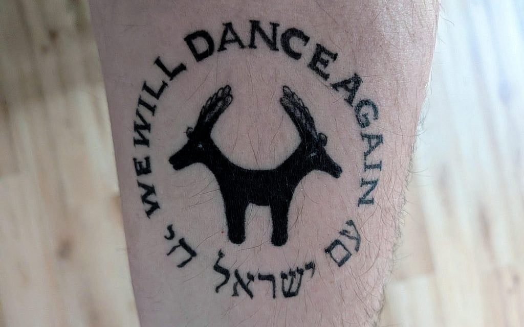 'Am Yisrael Chai' and 'We Will Dance Again' circling an ancient two-headed goat from the Israel Museum. My tattoo, from a trip to Israel in March 2025 (Daniel Blain)