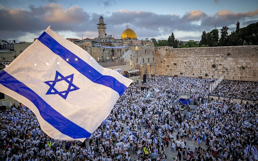 Jews hold Israeli flags as they dance at the Western Wall in Jerusalem's Old City, during Jerusalem Day celebrations, May 18, 2023. (Photo by Yonatan Sindel/Flash90)