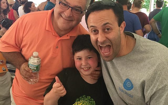 Rafi (center) celebrates with his Grandfather (left) and Uncle (right) at Ramah Nyack's Zimriyah Song Festival, July 2015.