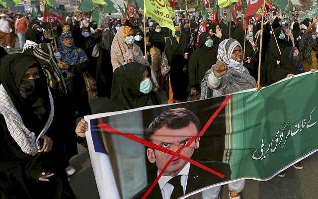 Shiite Muslim women march toward the French Consulate during a rally against French President Emmanuel Macron and the republishing of caricatures of the Prophet Muhammad they deem blasphemous, in Karachi, Pakistan, Sunday, Nov. 1, 2020. (AP Photo/Fareed Khan)