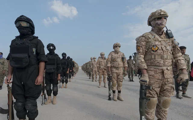 Troops from Iran's Islamic Revolutionary Guard Corps stand at attention during the IRGC's drill in the Persian Gulf, on February 16, 2026. (Sepahnews via AP)