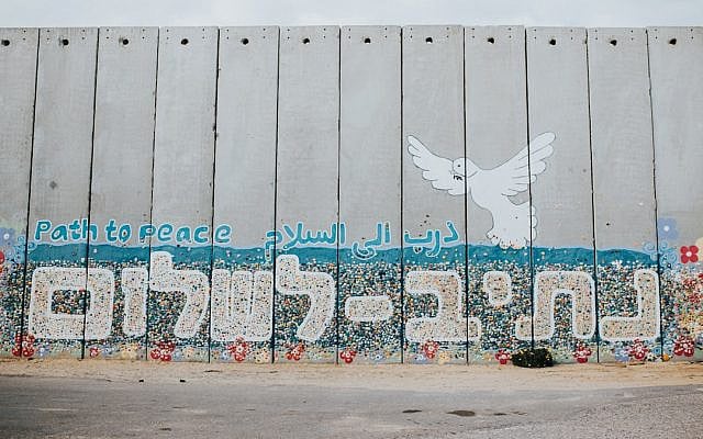 A wall at Netiv HaAsara facing the Gaza border reads the words “Path to Peace” in Hebrew, Arabic, and English. (Photo by Cole Keister/Unsplash)