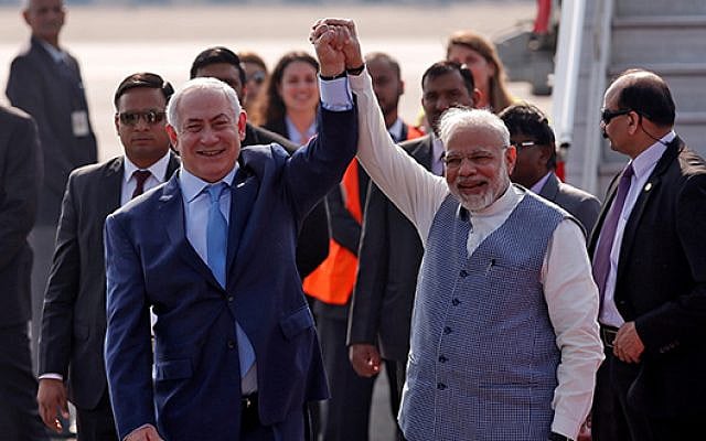 Israeli Prime Minister Benjamin Netanyahu and his Indian counterpart Narendra Modi raise their arms upon Netanyahu’s arrival at Air Force Station Palam in New Delhi, India, January 14, 2018. REUTERS/Adnan Abidi