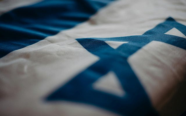 Detail of the Israeli national flag highlighting the Star of David, emphasizing its cultural significance as from the Pexels website (https://www.pexels.com/photo/close-up-of-the-flag-of-israel-4033852/).