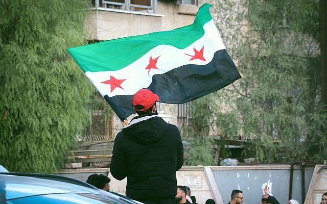Syrian Flag Raised in Patriotic Demonstration, photograph by Hala Hejazy, 2025. Source: Pexels
. This image is free to use under the Pexels License, including commercial use without attribution.