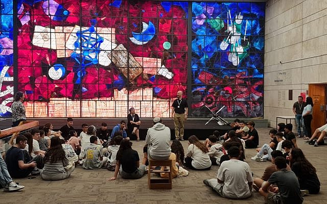 A class is held in front of the iconic stained glass windows at the old National Library of Israel building in Jerusalem, in an undated photo. (Source: The Times of Israel)