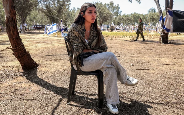 Guy Shema, one of the survivors of the October 7 attack on the Supernova music festival by Palestinian terrorists, speaks to journalists after returning to the site near Kibbutz Reim in southern Israel on April 10, 2024. (JACK GUEZ / AFP)