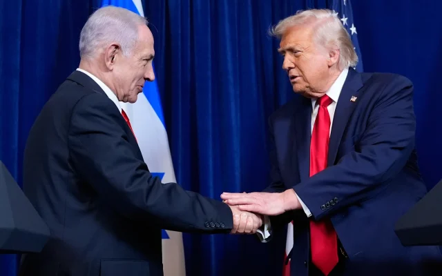 US President Donald Trump, right, shakes hands with Prime Minister Benjamin Netanyahu during a news conference at Mar-a-Lago, on December 29, 2025, in Palm Beach, Florida. (AP Photo/Alex Brandon)