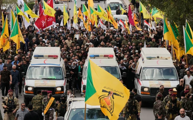 Members of an Iraqi Shiite group attend a funeral of a Kataeb Hezbollah fighter, who was killed in a US airstrike in Basra province south of Baghdad, Iraq, on April 8, 2026. (AP Photo/Hadi Mizban)
