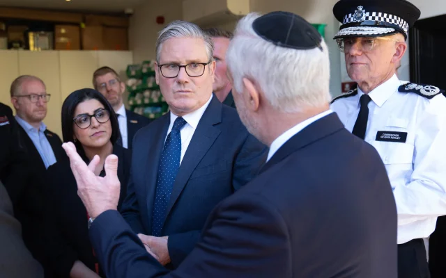 Britain's Prime Minister Keir Starmer, center, Metropolitan Police Commissioner Mark Rowley, right, and Home Secretary Shabana Mahmood, 2nd left, speak with members of the Jewish community during a visit to Golders Green, north west London, Thursday April 30, 2026, following an attack in which two men were stabbed. (Stefan Rousseau/Pool via AP)