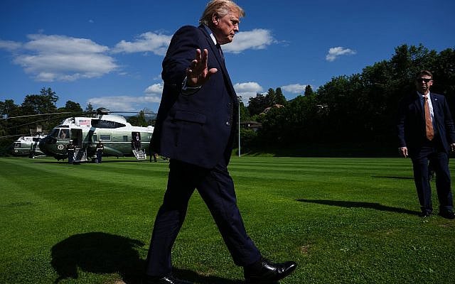 President Donald Trump waves to reporters as he arrives for the G7 summit, Monday, June 15, 2026, in Evian-les-Bains, France. (AP Photo/Julia Demaree Nikhinson)