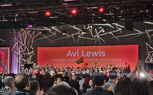 Avi Lewis at the podium after securing the leadership of the NDP on March 29, 2026. Image retrieved with permission from https://x.com/BenNephrology/status/2038286722086375731/photo/1 Avi Lewis at the podium after securing the leadership of the NDP on March 29, 2026. Image retrieved with permission from https://x.com/BenNephrology/status/2038286722086375731/photo/1