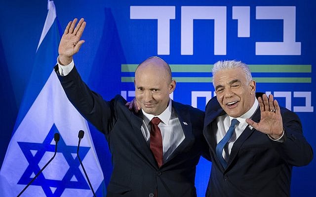 Former prime minister Naftali Bennett, left, and Opposition Leader Yair Lapid announcing their joint run in the coming elections, in Herzliya, April 26, 2026. (Chaim Goldberg/Flash90)