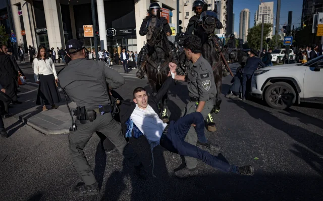 Ultra-Orthodox Jewish men clash with police in Jerusalem during a protest against the jailing of seminary students who failed to comply with military enlistment orders, May 7, 2026. (Chaim Goldberg/Flash90)