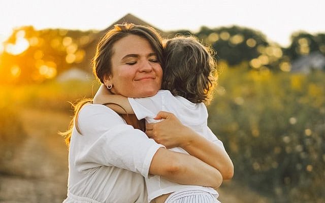 Illustrative. A woman hugs her son. (iStock)