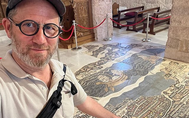 The author standing in front of the 6th-century Madaba map, pointing to the section that depicts Jerusalem. (photo taken by the author) The author standing in front of the 6th-century Madaba map, pointing to the section that depicts Jerusalem. (photo taken by the author)