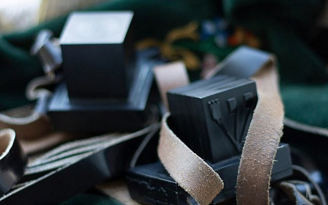 Tefillin contain four passages from the Torah, one for each time the commandment to wear them appears in the text. Photo by Menachem Weinreb on Unsplash.