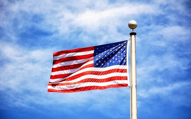 Vibrant American flag flying against a clear blue sky, symbolizing freedom and patriotism from the website Pexels, free download for non-commercial use (https://www.pexels.com/photo/us-a-flag-on-pole-under-blue-sky-7483195/).