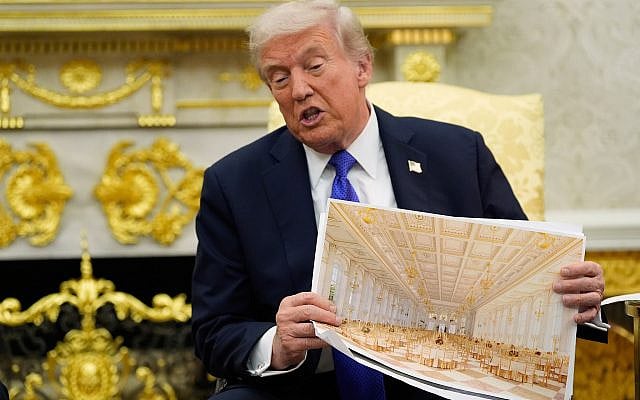 President Donald Trump holds an artist rendering of interior of the new White House ballroom, in the Oval Office of the White House, Oct. 22, 2025 (AP Photo/Alex Brandon)