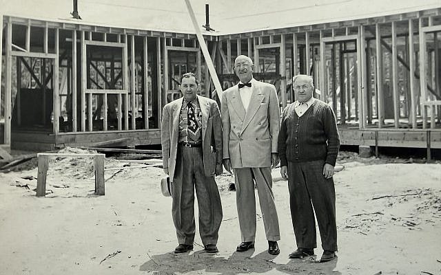My Zadie, Eddie Goverman (left), at the construction of one of the suburban Boston schools his company built during the postwar years. Only recently did I come to appreciate what he was really building.