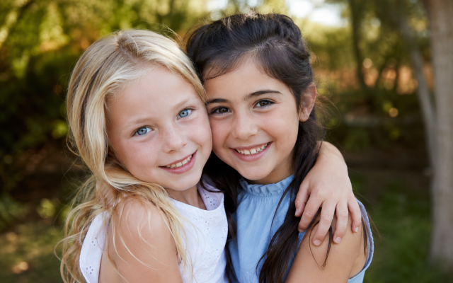Two young girls hugging (Chat GPT, 14-7-2026)