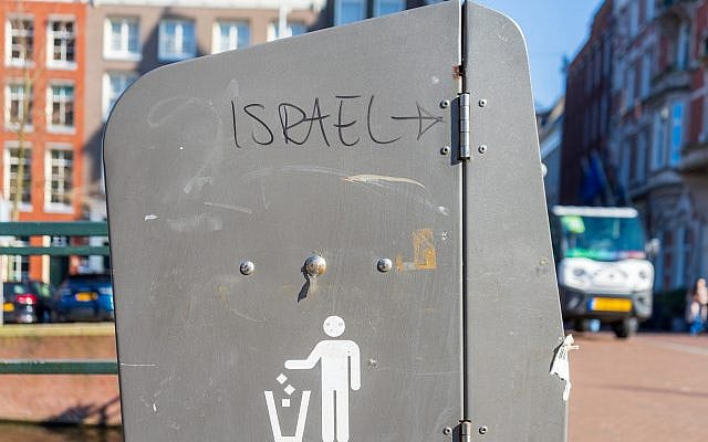 Amsterdam, Netherlands - March 03. 2025.

A graffiti reading “Israel →” on a public bin in Amsterdam highlights antisemitic vandalism and persistent hate-speech in urban spaces. (Shutterstock)