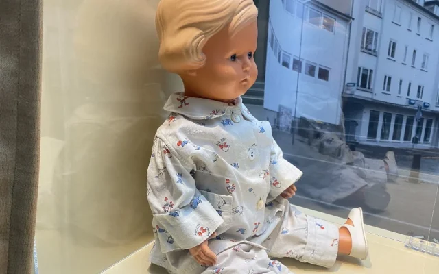 An 80-year-old blonde baby doll belonging to a Holocaust survivor on display during the opening of an exhibition of 16 objects lent from Yad Vashem on display at the Paul-Loebe-Haus parliamentary building in Berlin, January 24, 2023. (Julien GATHELIER / AFP)