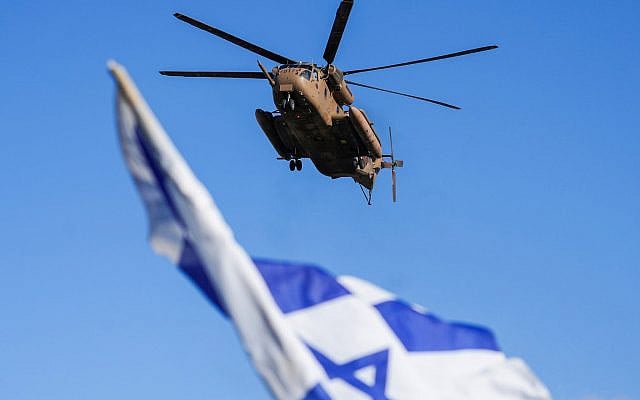 An Israeli military helicopter flies above an Israeli flag. (AP Photo) An Israeli military helicopter flies above an Israeli flag. (AP Photo)