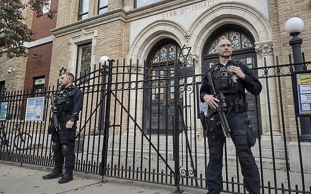 Illustrative: Hoboken Police officers stand watch outside the United Synagogue of Hoboken, Nov. 3, 2022, in Hoboken, N.J. (AP Photo/Ryan Kryska, File)
