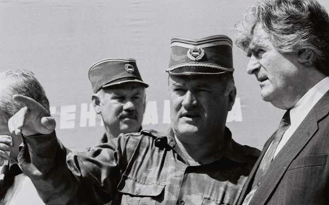 Bosnian Serb General Ratko Mladic, center, speaks with Bosnian Serb President Radovan Karadzic, right, in the Bosnian town of Banja Luka, in 1994. (AP Photo/Radivoje Pavicic)