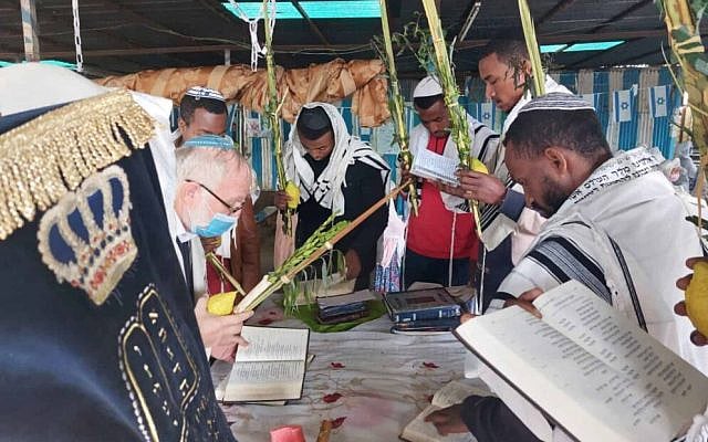 Ethiopian Jews paying inside a sukkah. (via Facebook)