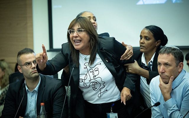 Yesh Atid MK Debbie Biton taken out by Knesset guards during a a Constitution, Law and Justice Committee meeting, at the Knesset in Jerusalem, on June 25, 2023. (Yonatan Sindel/ Flash90/ File)