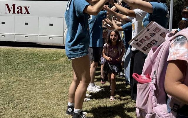 a team of counselors welcoming Prager's daughter to camp