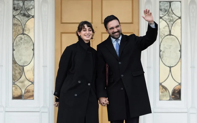 New York Mayor Zohran Mamdani, right, and his wife Rama Duwaji wave at members of media after a news conference at Gracie Mansion, January 12, 2026, in New York. (AP/Yuki Iwamura)