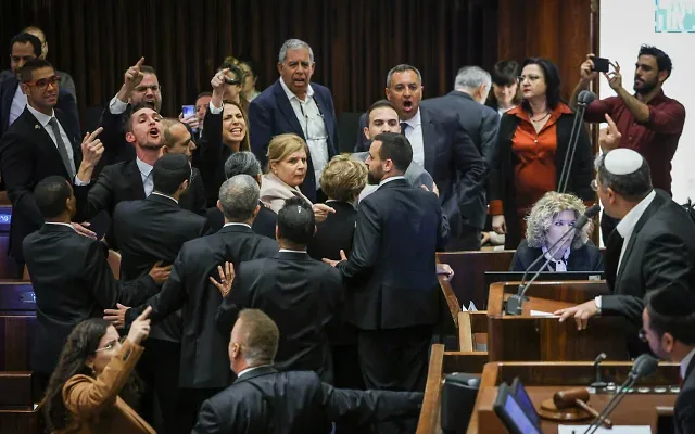 Minister Itamar Ben Gvir speaks from the podium, right, and opposition members shout at him from the side, in the Knesset, on March 22, 2023. (Noam Moskowitz/Knesset) Minister Itamar Ben Gvir speaks from the podium, right, and opposition members shout at him from the side, in the Knesset, on March 22, 2023. (Noam Moskowitz/Knesset)