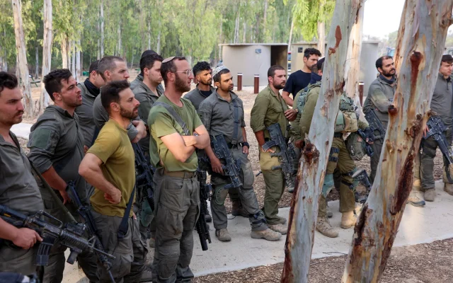 Illustrative: Israeli soldiers gather near the border with Gaza before entering the Hamas-run enclave on October 31, 2023. (Gil COHEN-MAGEN / AFP)
