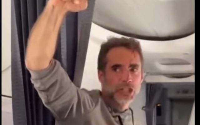 Asaf Rajuan pumps his fist in the air, informing passengers of the success in subduing the terrorist copilot and taking control of flydubai's Flight 1073. (Screencapture, social media)