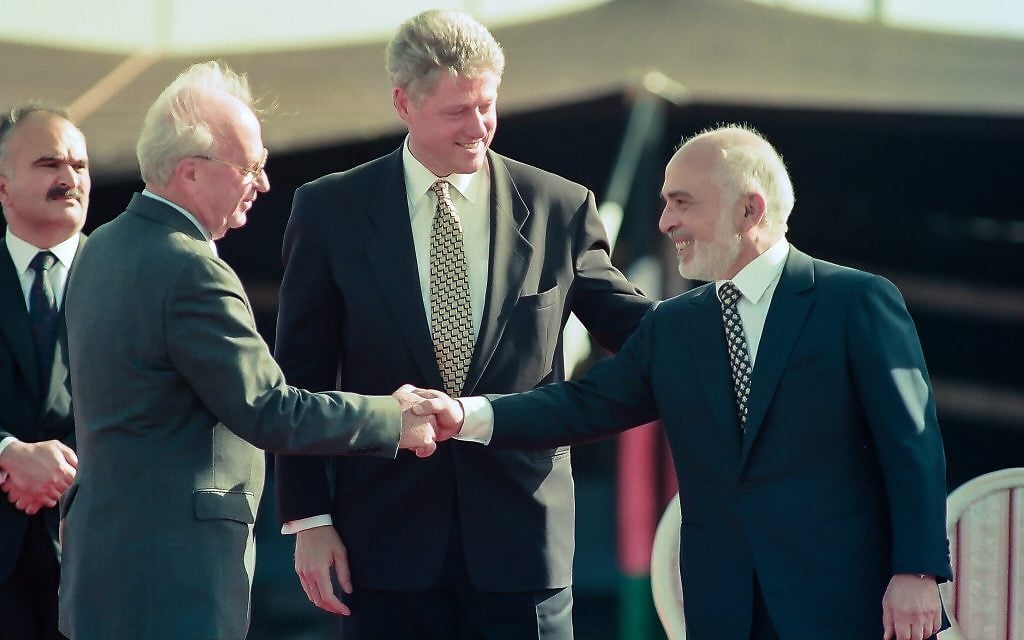 Prime Minister Yitzhak Rabin and Jordan's King Hussein shake hands after the signing of the Israel-Jordan Peace Treaty, at the Wadi Araba border crossing, October 26, 1994. (Moshe Shai/FLASH90)