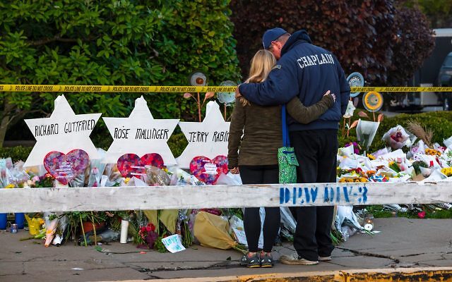 Pittsburgh, Pennsylvania / USA – Oct 30 2018: Chaplain Bob Ossler of Cape Coral FL comforts members of the community outside of the Tree of Life synagogue in Pittsburgh.