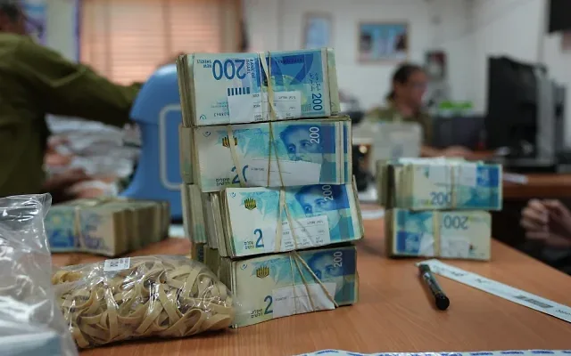 Cash seized by the IDF in the Gaza Strip is seen being counted before being deposited at the Bank of Israel, April 18, 2024. (Defense Ministry)