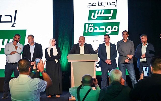 On October 27, Amnesty International UK declared that Israel’s election exposed “apartheid at the ballot box.” Image: Ra’am (Arab) party leader Mansour Abbas and other party members stand on stage following the release of exit poll results in Sakhnin, Israel, on October 27, 2026. (Michael Giladi/Flash90)