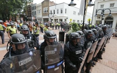 Virginia State Police cordon off an area around the site where a car ran into a group of protesters after a white nationalist rally in Charlottesville, Va., Saturday, Aug. 12, 2017. (AP Photo/Steve Helber)