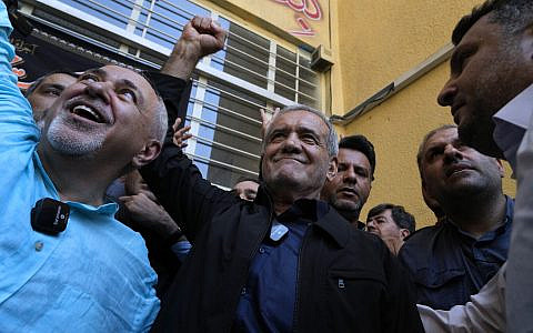 Reformist presidential candidate Masoud Pezeshkian raises a clenched after casting his vote in the presidential election, outside a polling station in Shahr-e-Qods, Iran, July 5, 2024. (AP Photo/Vahid Salemi)