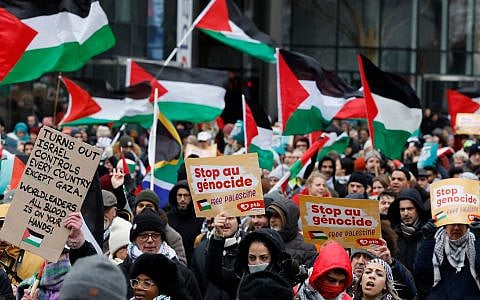Demonstrators hold signs and wave flags during a pro-Palestinian, anti-Israel rally in Brussels, January 21, 2024. (AP Photo/Geert Vanden Wijngaert)